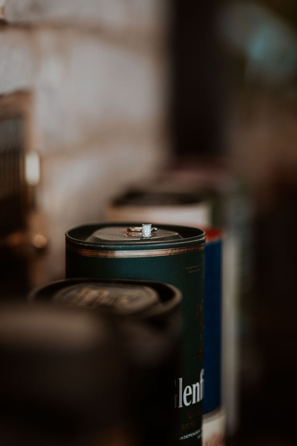 Close-up macro shots of a metal can with blue details shown from various angles in shallow depth of field.