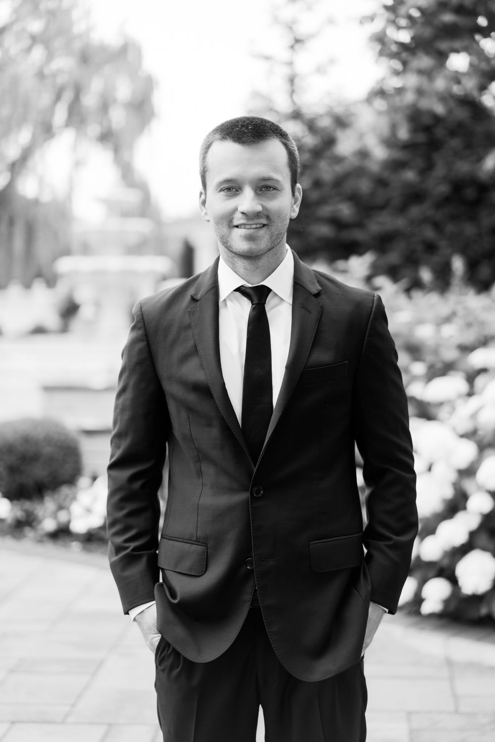 Black and white portrait series of a formally dressed person in a classic suit and tie.