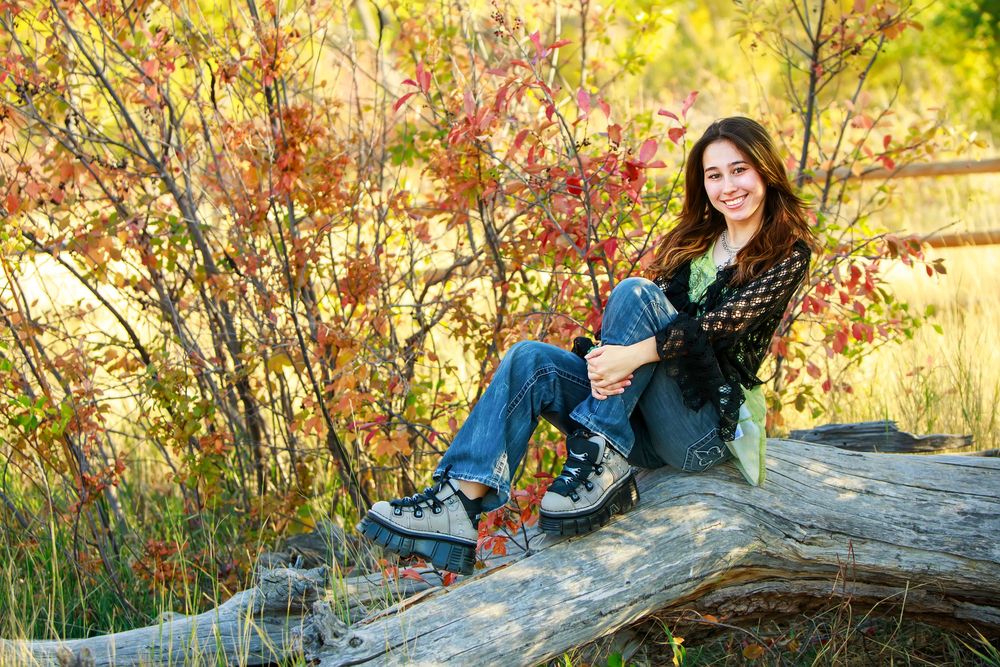 A panoramic series of fall family portraits captured against vibrant autumn foliage and a rustic stone wall.