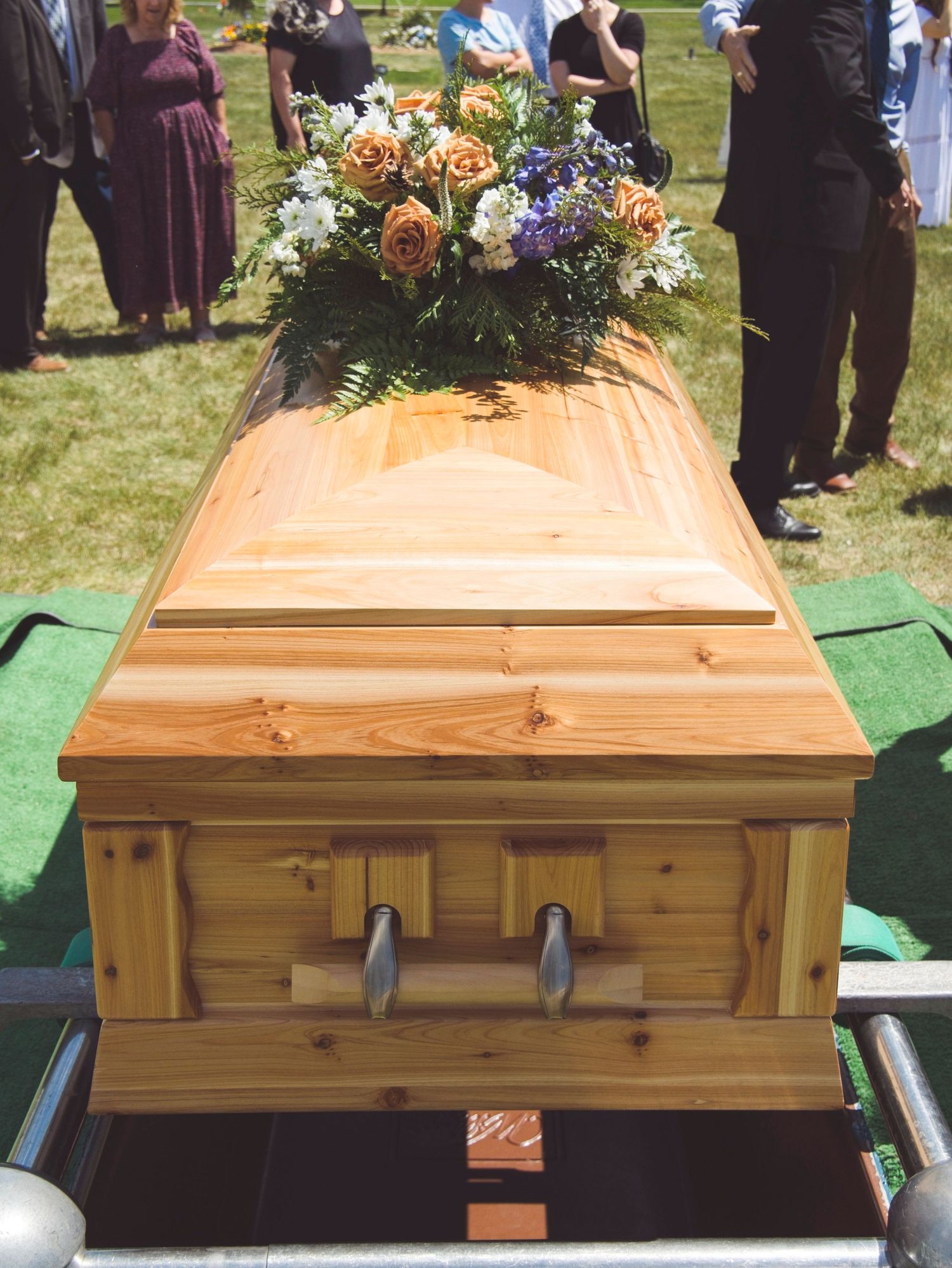 The casket with a flower arrangement on top