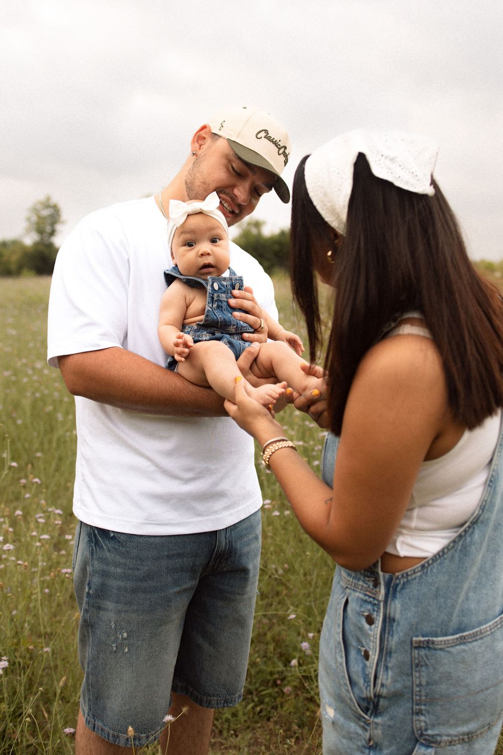 Family spending time together in a wildflower meadow on a summer day.