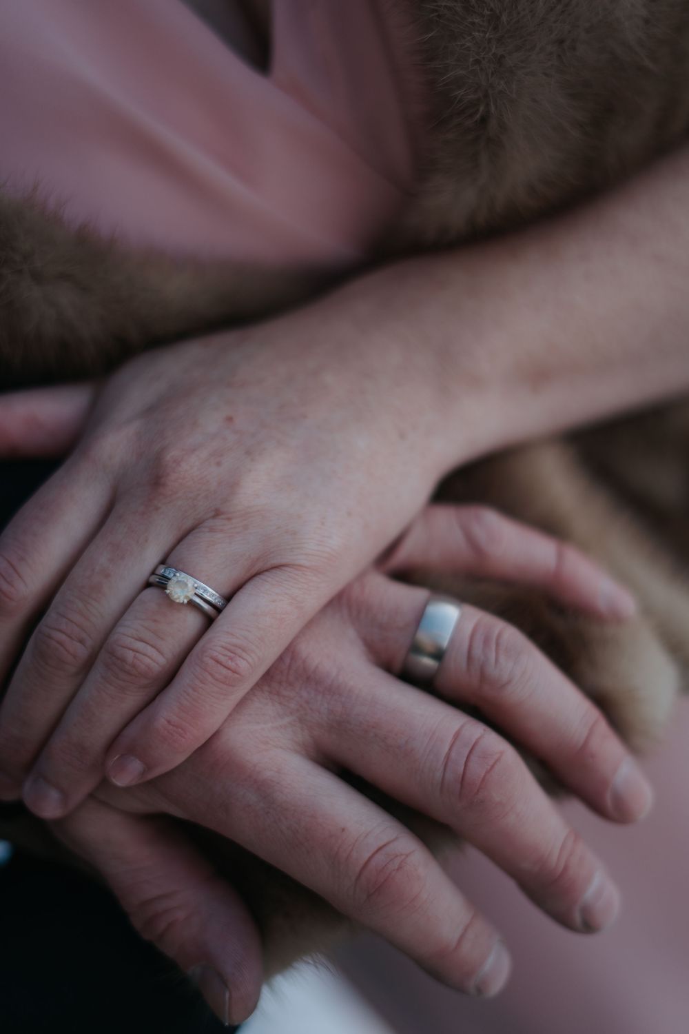 Close-up of newlywed couple's hands showing wedding rings.