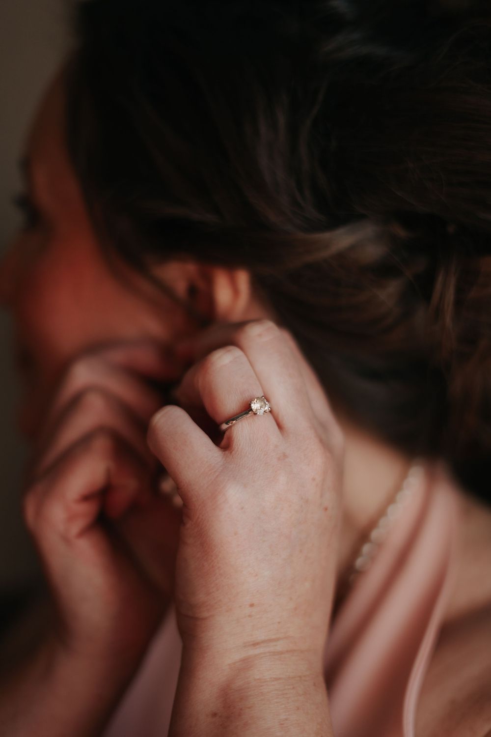 Close-up of a delicate engagement ring on a hand.