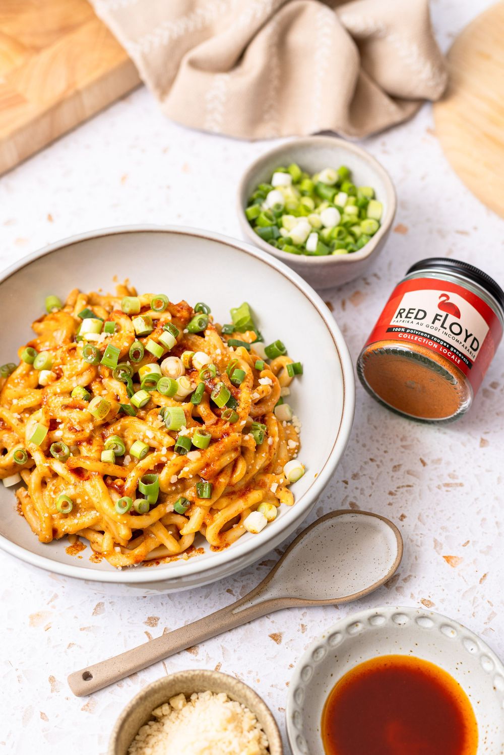 Spicy pasta dish topped with green onions, served with Red Floyd seasoning, fresh scallions, parmesan, and sauce.