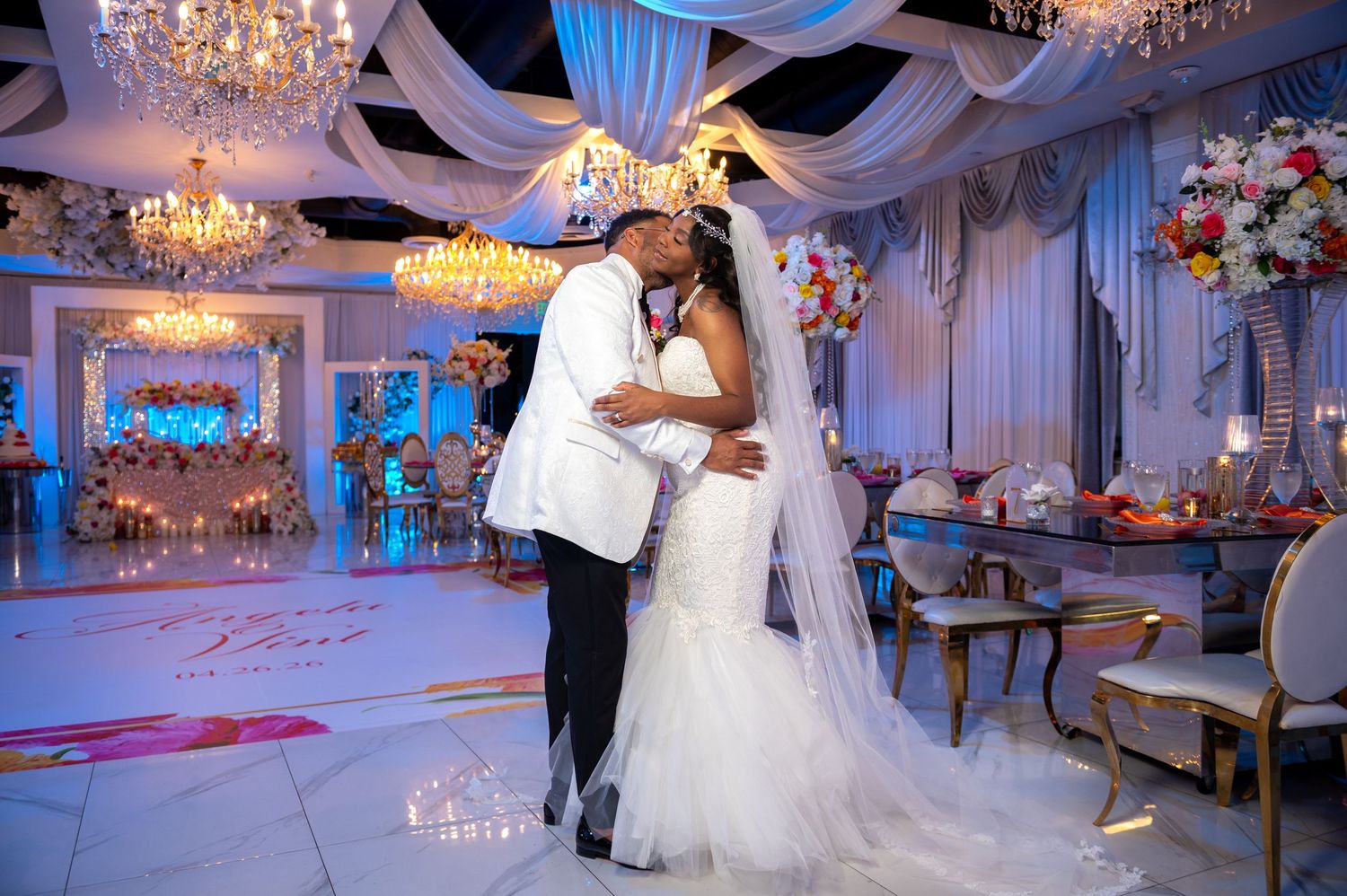 The couple embraces on the dance floor at the Crystal Ballroom Beachplace, captured by wedding photographers in Palm Beach.