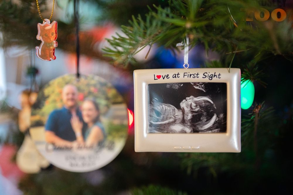Christmas tree ornament frame reading Love at First Sight displaying baby ultrasound photo.