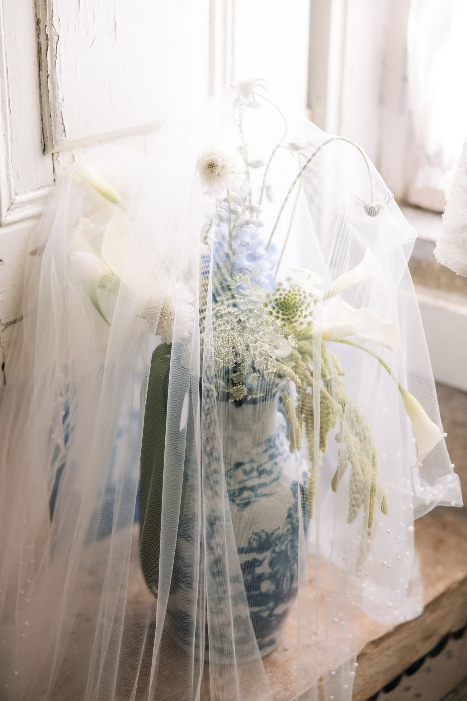 Conceptual bridal bouquet portrait with veil in Portugal