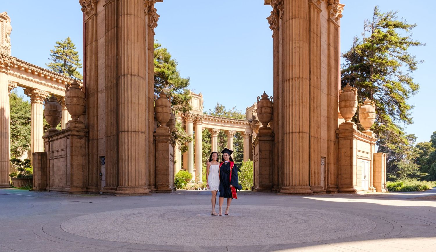 Woman in black dress posing under grand stone arches at the Palace of Fine Arts, San Francisco.