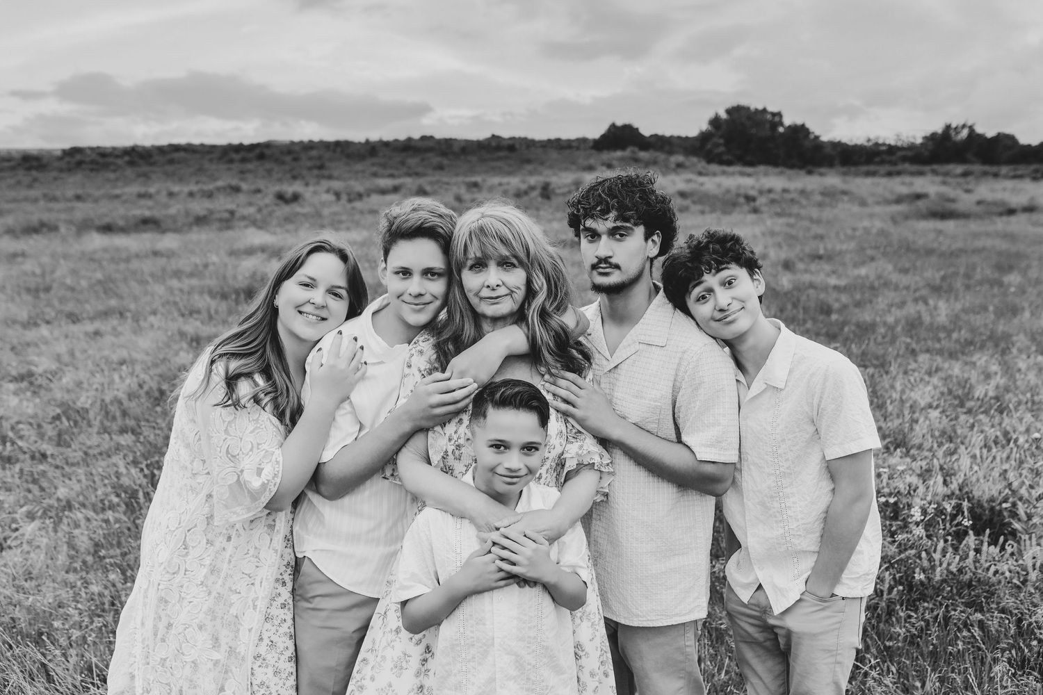 Grandmother holding her grandchildren during an outdoor family photo session