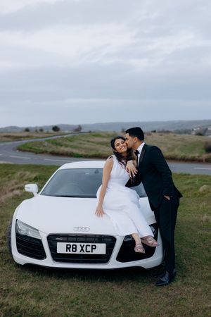 Couple laughing during engagement photography session in the Cotswolds.