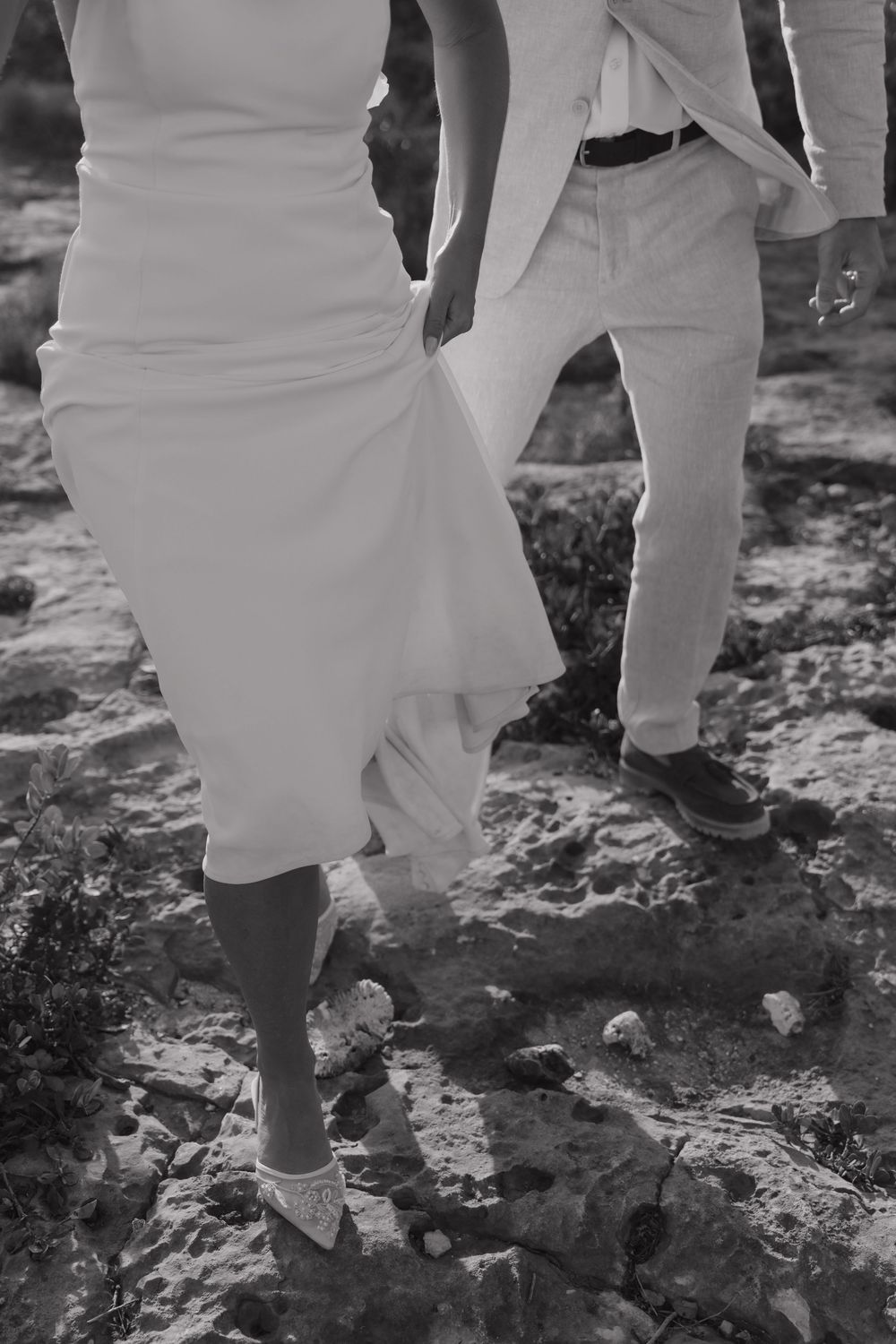 Romantic barefoot detail of the bride and groom walking on the sand during their Riviera Maya wedding couple session.