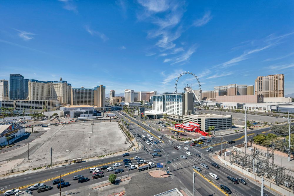 Aerial view of the Las Vegas Strip featuring the High Roller observation wheel and busy streets.