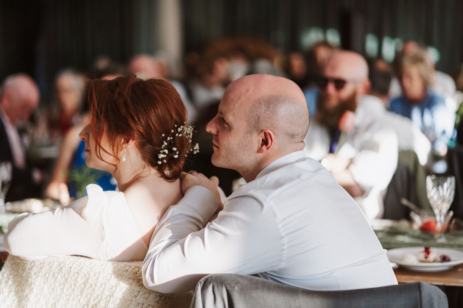 Bride and groom sharing an intimate moment at their wedding reception dinner.