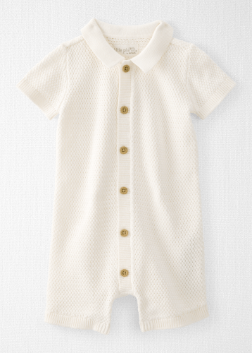 Cream knit baby romper with collar, short sleeves, and gold button front closure.