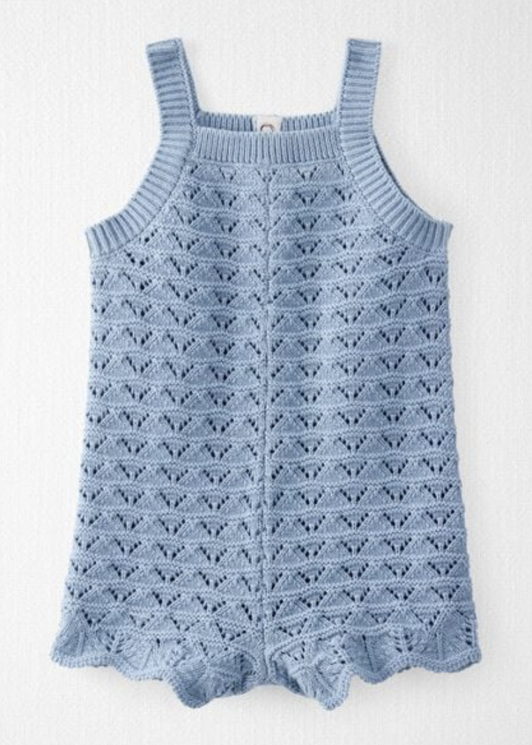 Blue crochet knit baby romper with lace pattern, square neck, tank straps, and scalloped hem.