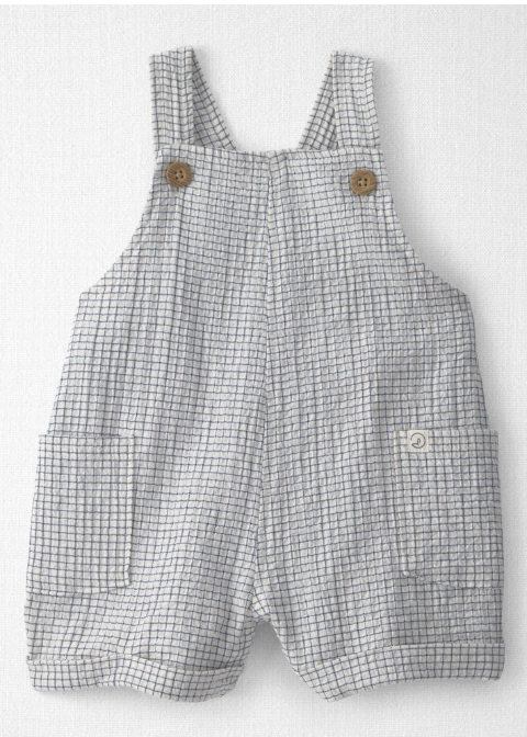 Baby grid-check romper with wooden buttons and front pockets in neutral white and gray linen fabric.