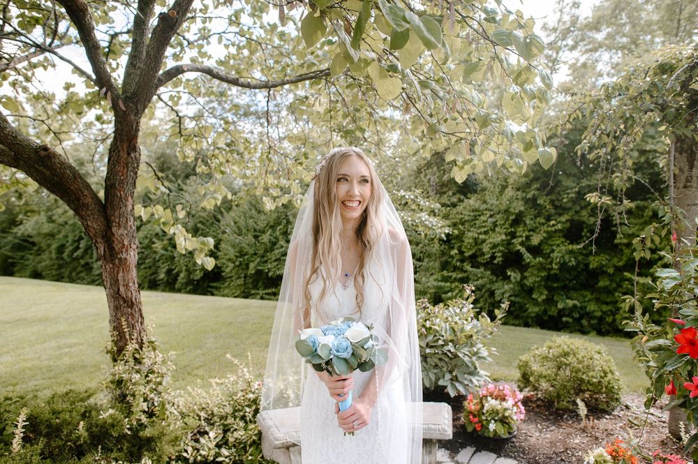 A romantic outdoor wedding scene in a lush garden setting with natural decor and floral arrangements.
