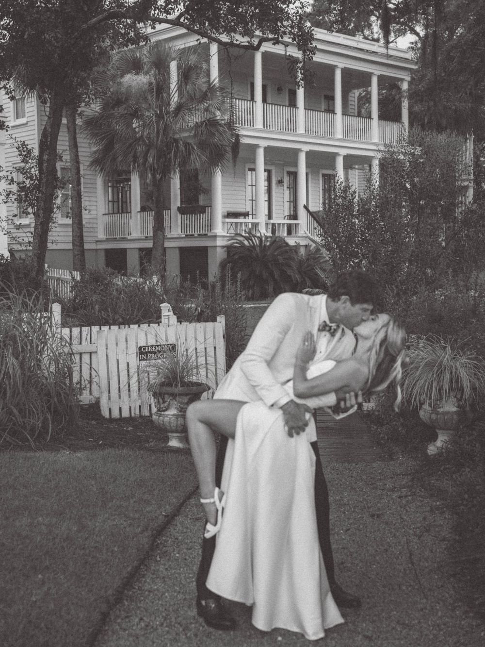 A romantic wedding photo session in front of a classic Southern mansion with white columns.