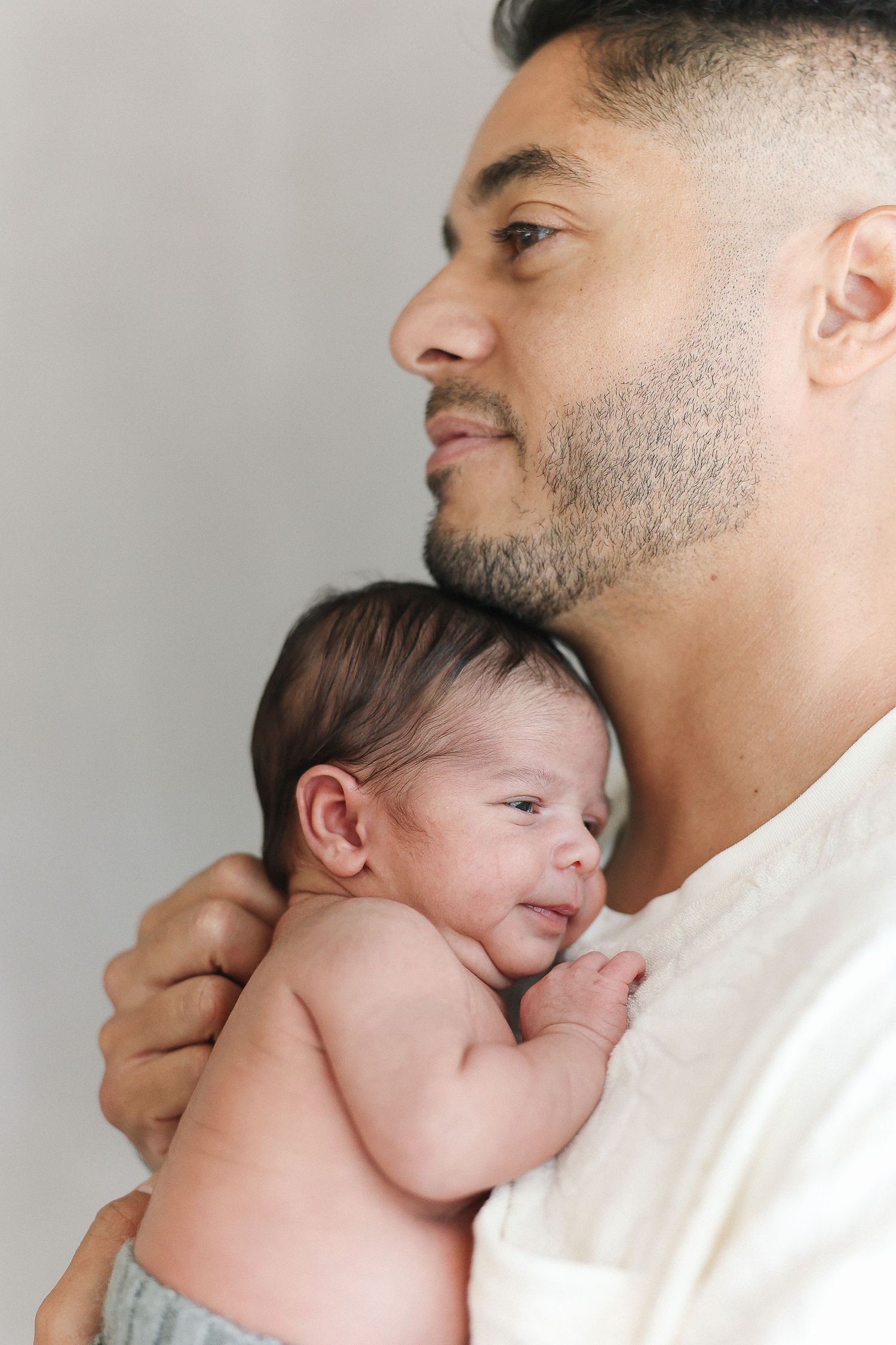 Candid newborn photography session with dad at Spark Studios Huntington Beach