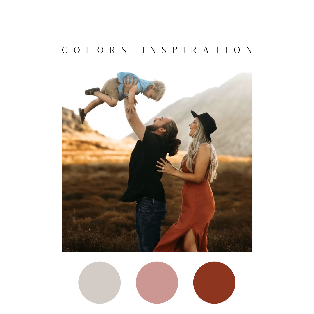 Parents playing with baby outdoors against mountain backdrop with warm color tones.