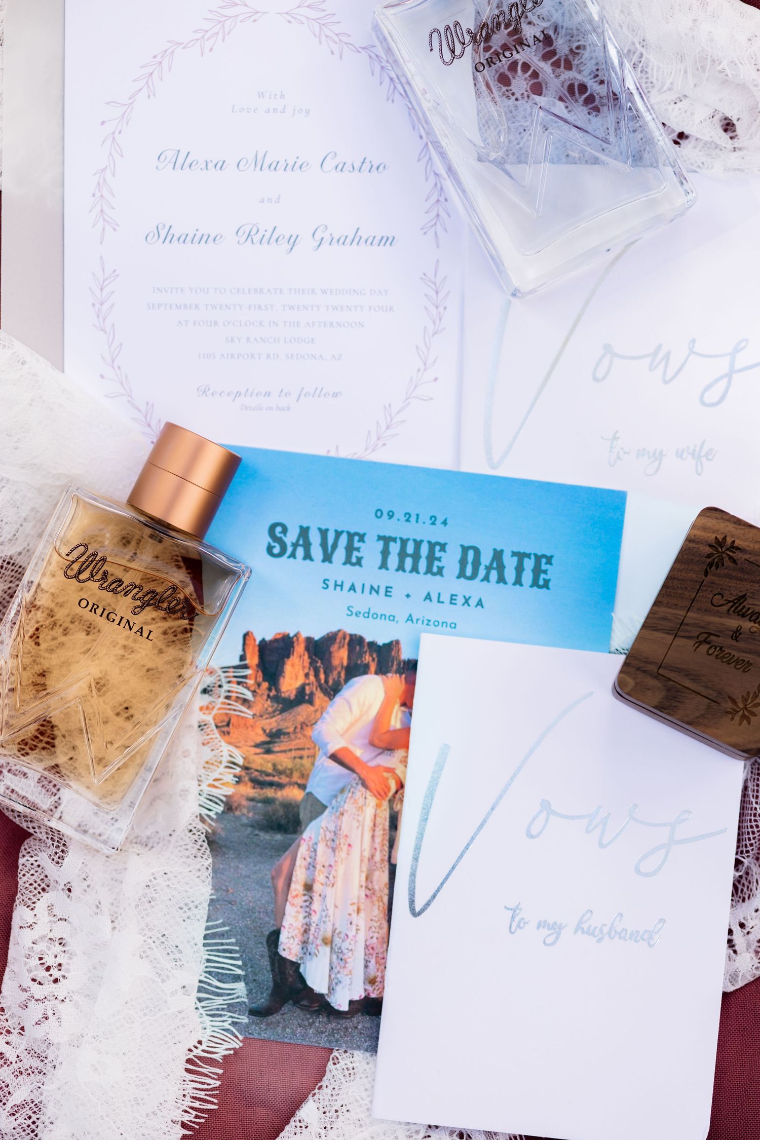 Wedding invitation designs and save the date cards spread out showing elegant paper stationery with handwritten details.