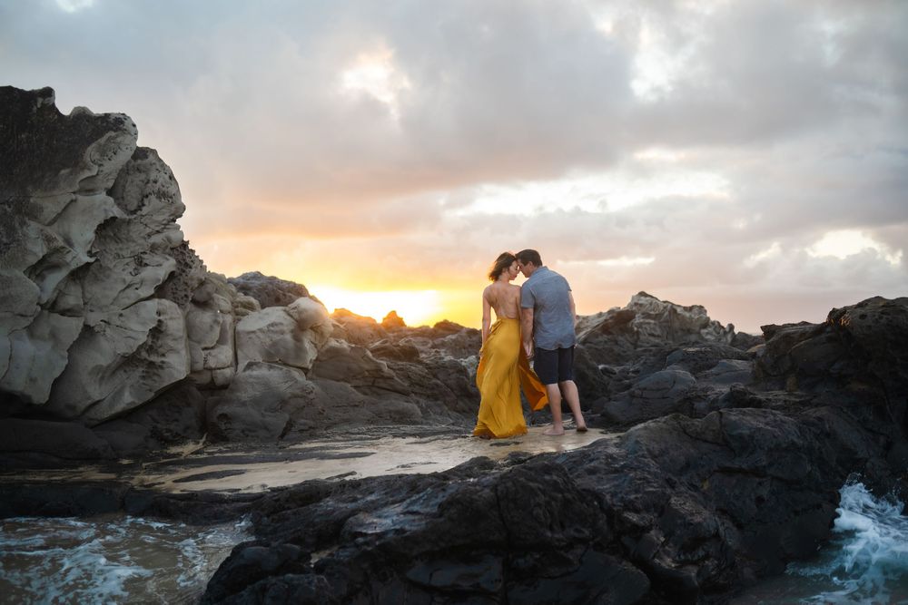 Maui couple engagement photographer photo against beautiful Maui sunset beach cliff by ohwowfotos.