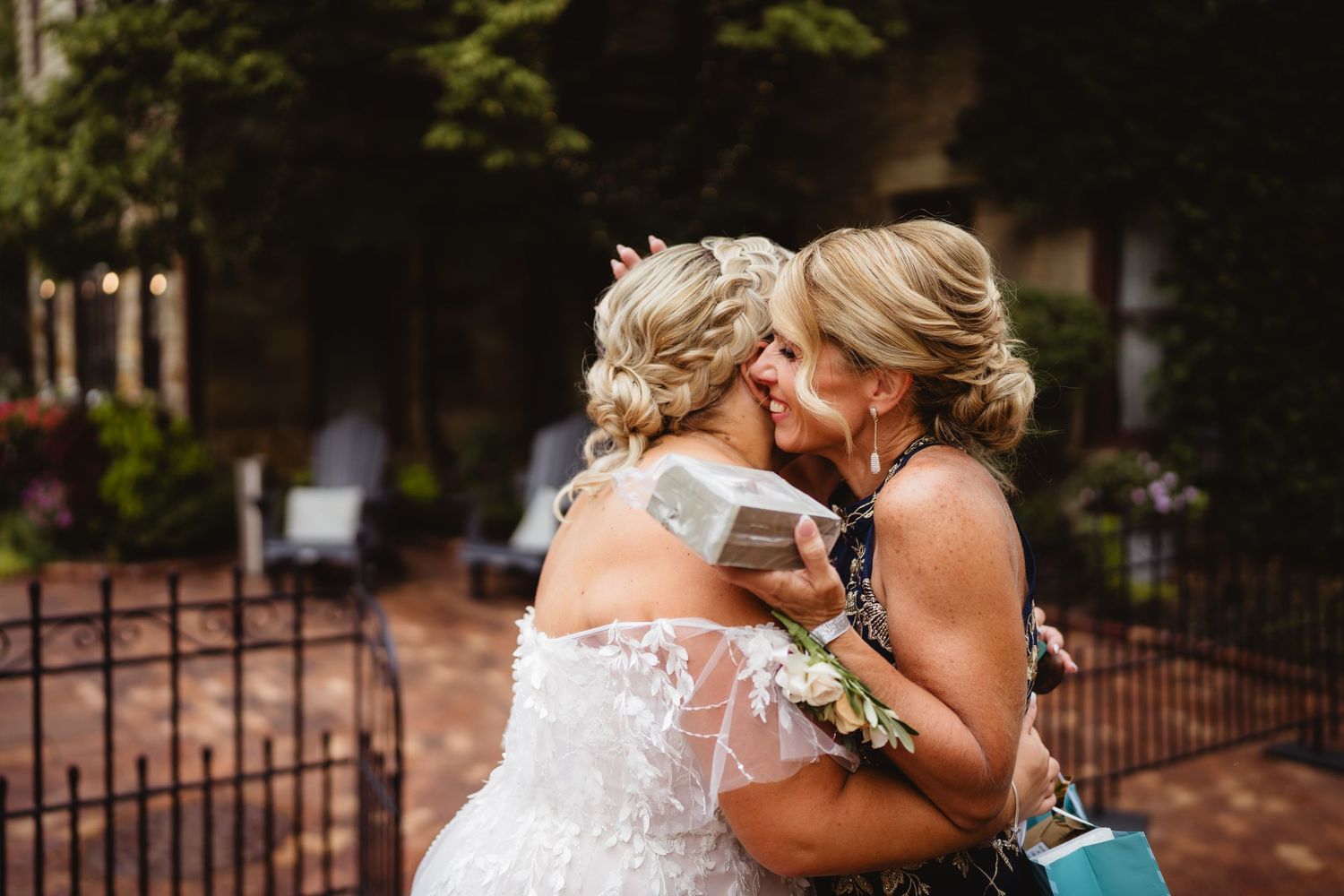 Newlywed couple shares intimate moments during their outdoor wedding photoshoot in a garden setting.