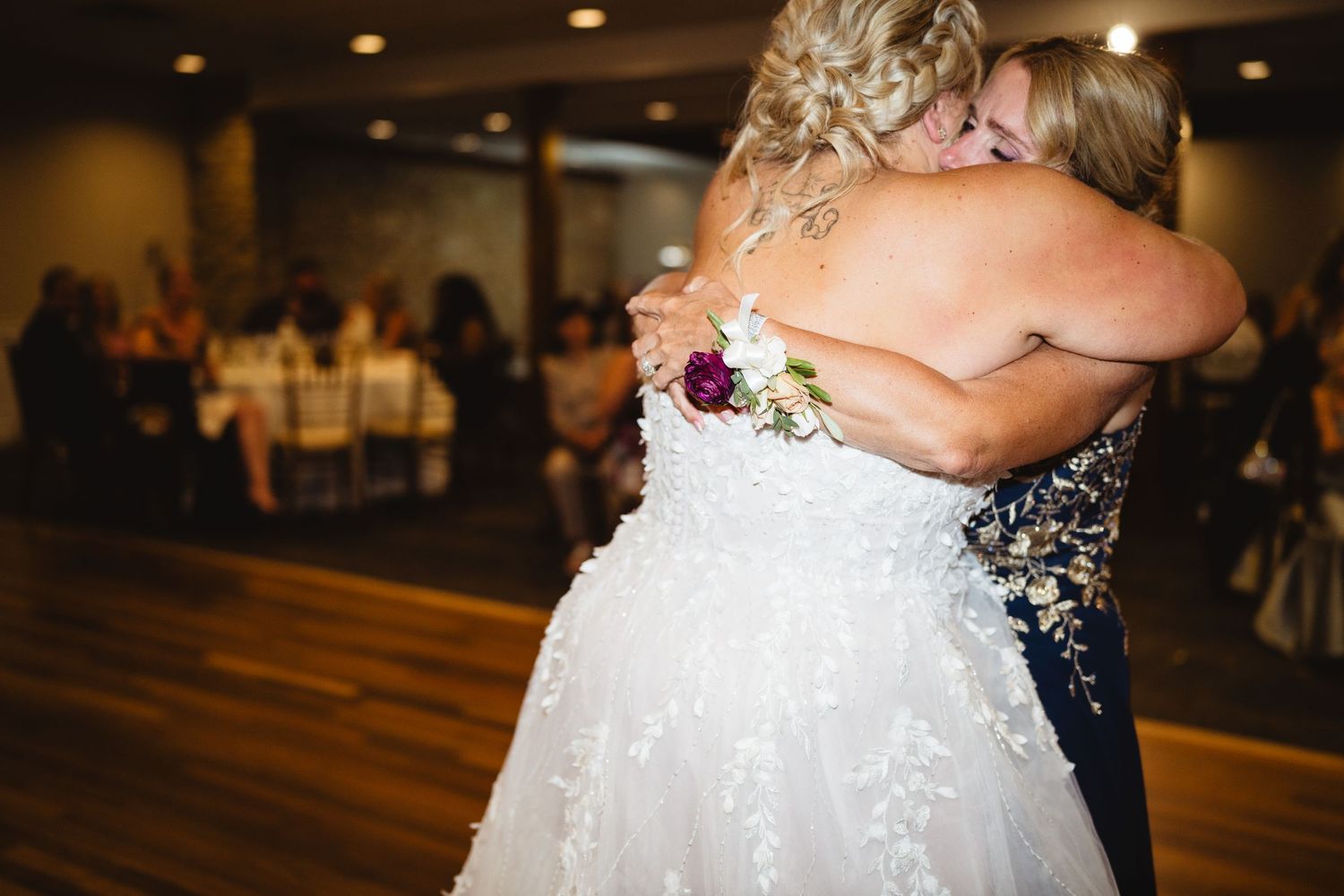 Wedding reception dance floor filled with joyful celebratory moments under warm lighting.