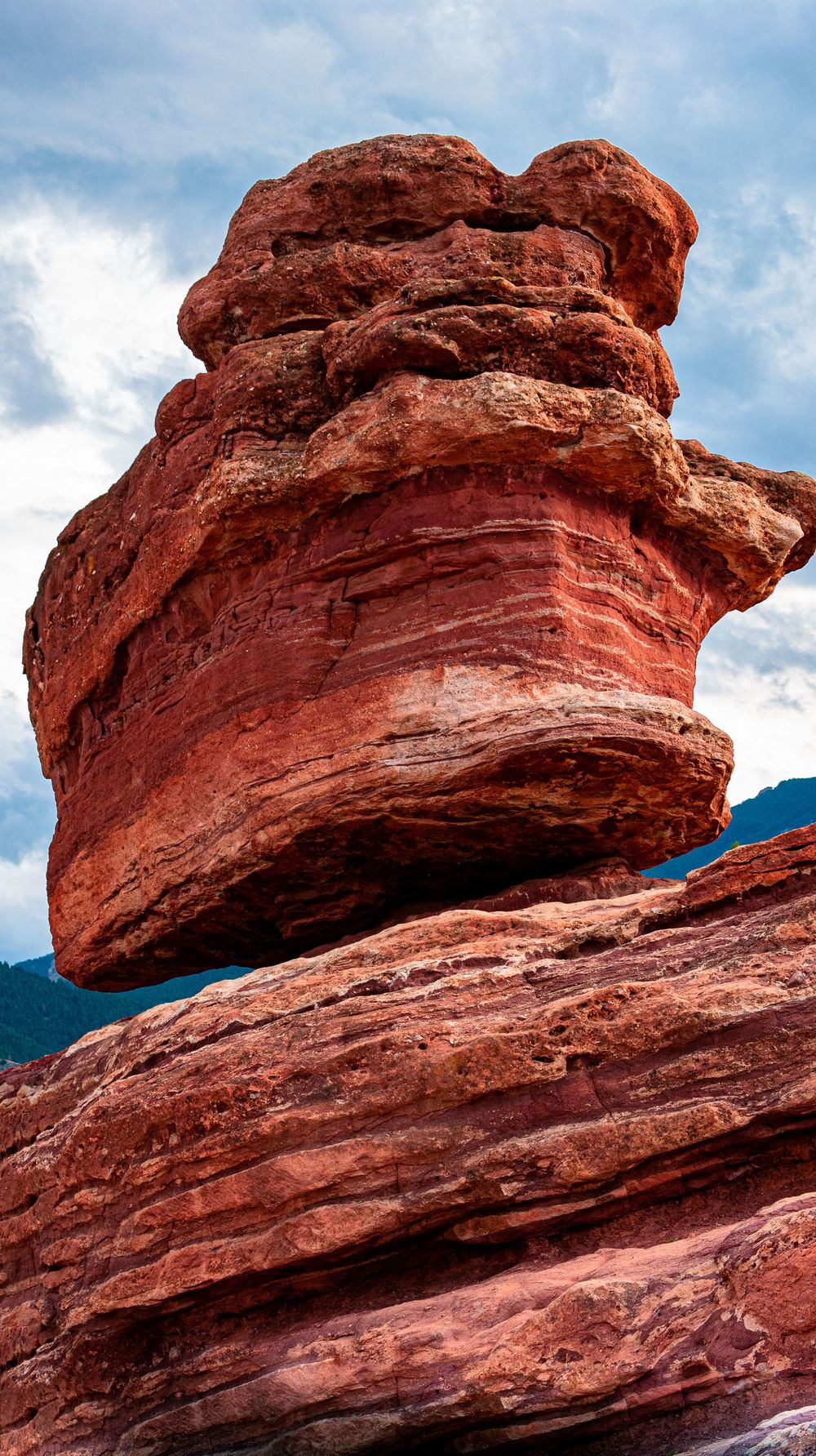 Close-up of layered red sandstone rock formation against blue sky at Garden of the Gods.