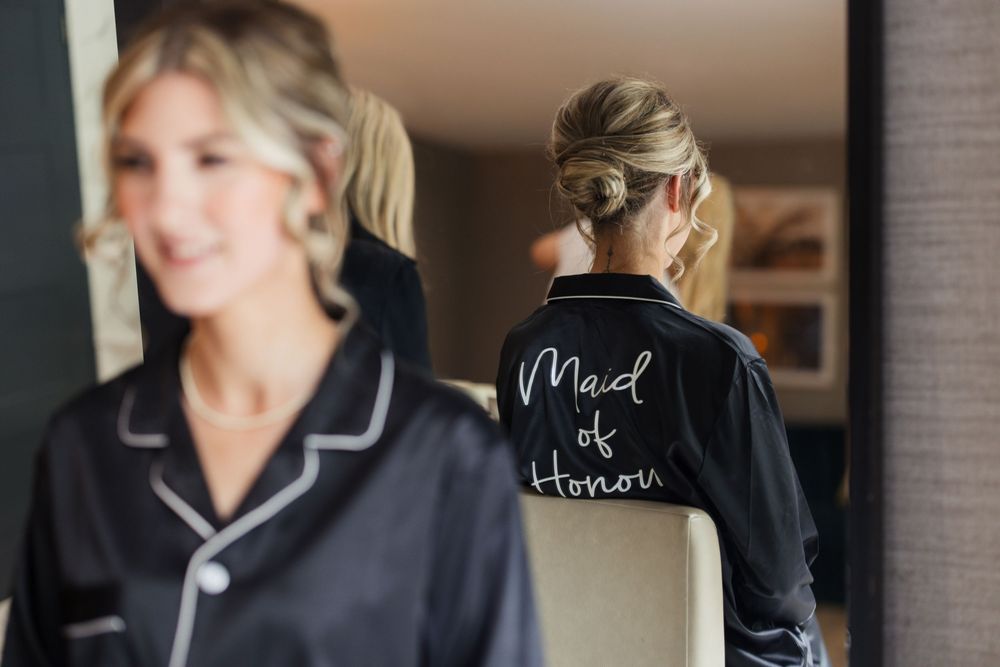 Wedding party getting ready in matching navy robes before the ceremony.