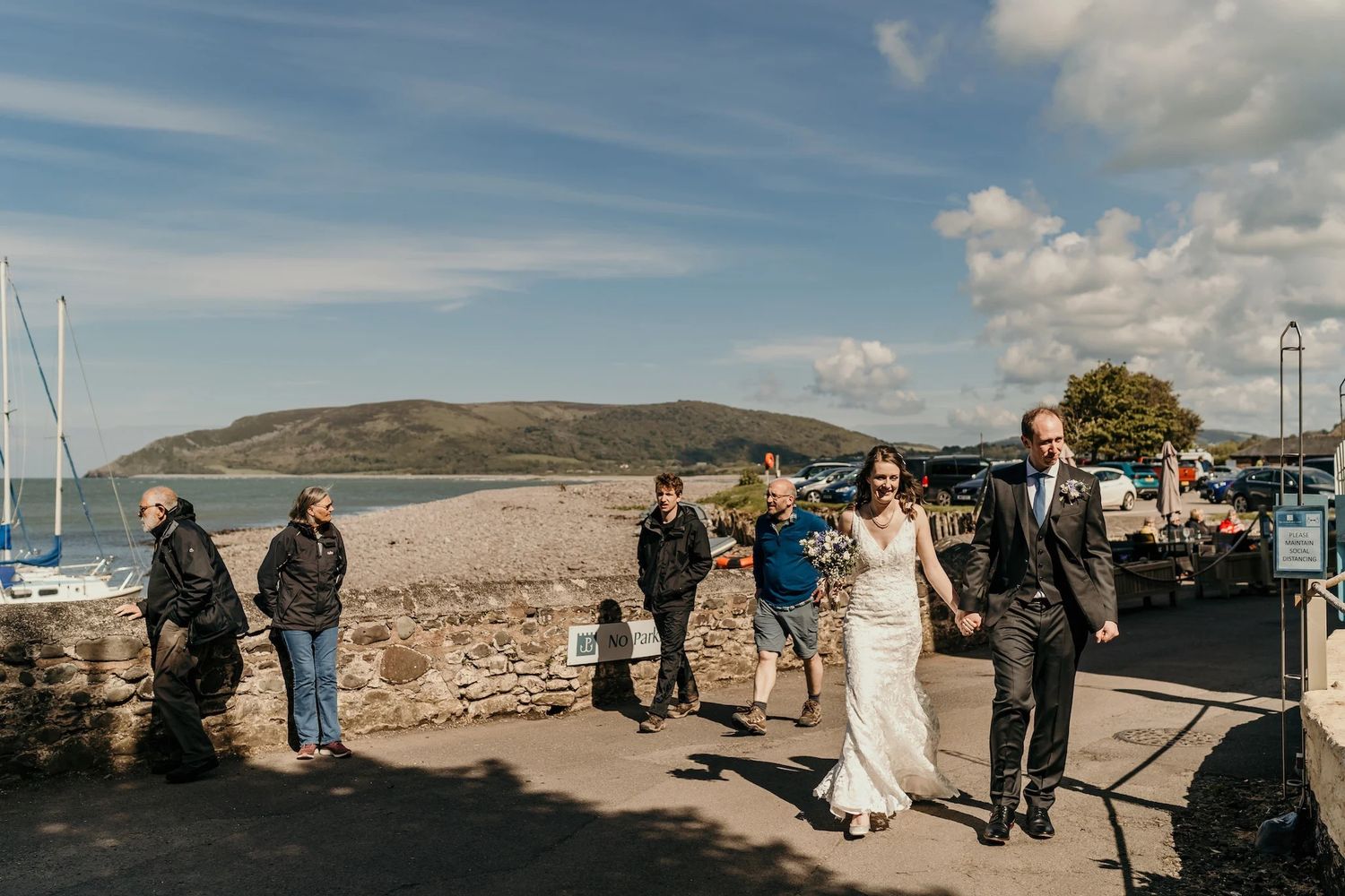Panoramic wedding photos on a hilltop showing dramatic clouds and coastal scenery.