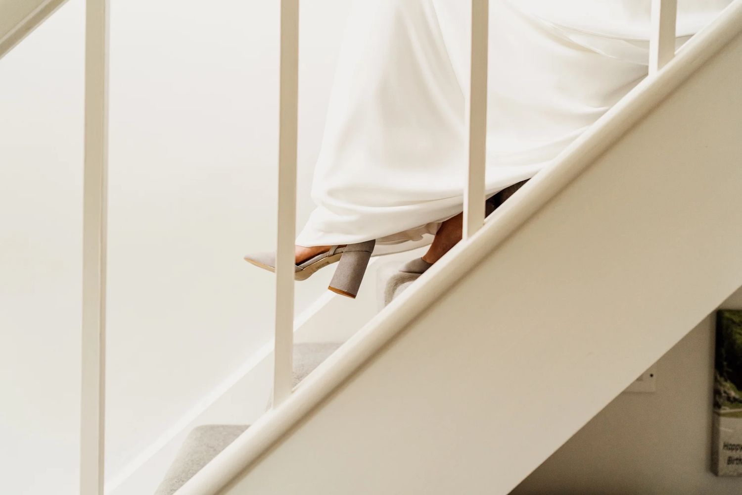White wooden staircase with natural light streaming in through window in modern rustic interior.