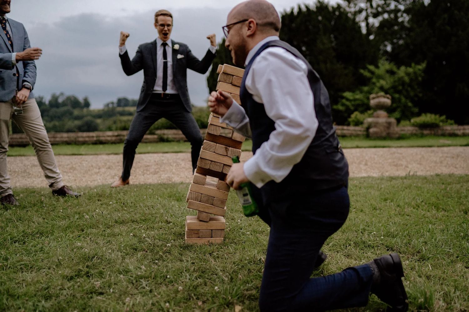 Series of action shots showing people playing Jenga outdoors at a casual gathering.