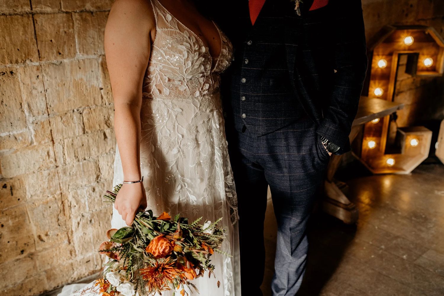 Rustic stone venue interior with warm lighting and event decorations for an intimate wedding celebration.