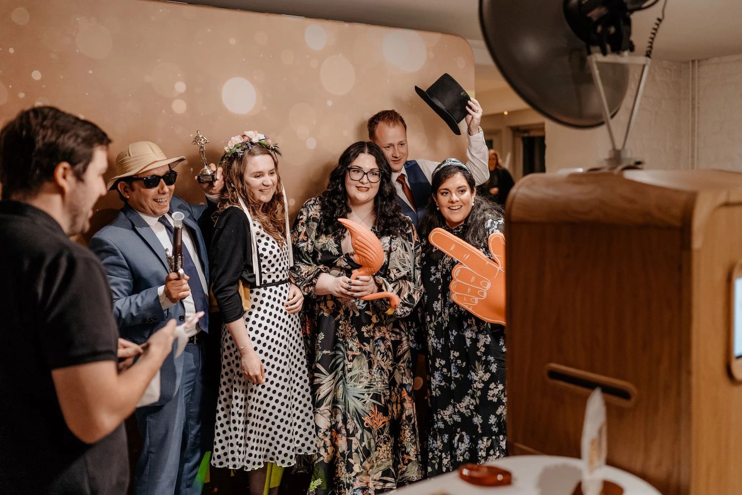 Wedding guests mingle and socialize during a lively indoor reception celebration.
