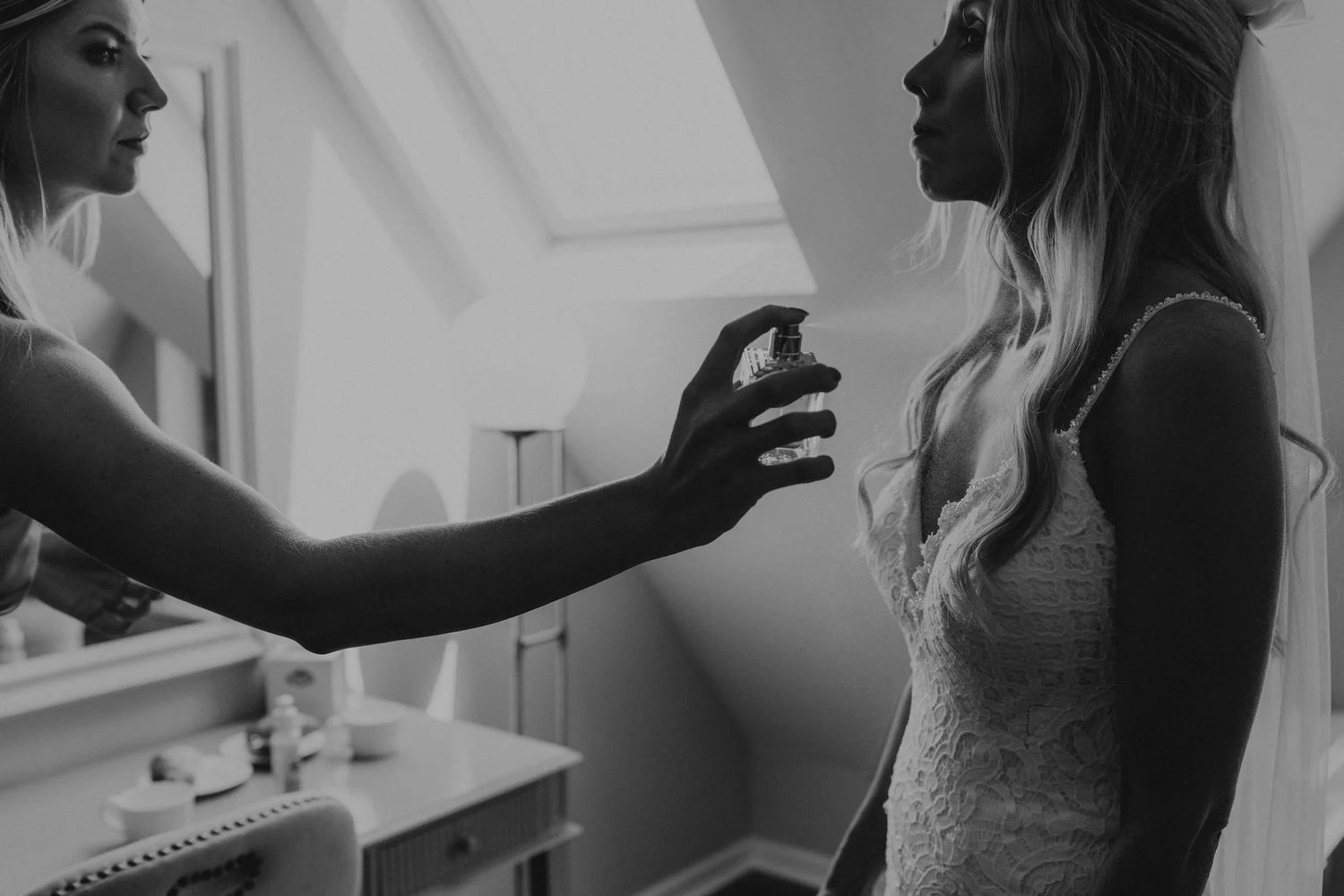 Wedding preparations captured in black and white showing intimate emotional moments between people getting ready.
