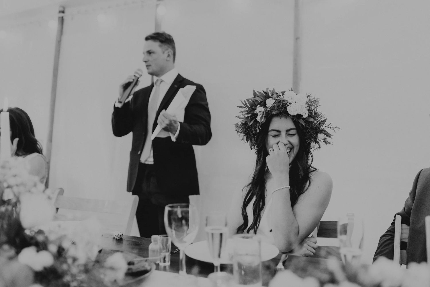 Wedding reception tables set with elegant decor and floral centerpieces.