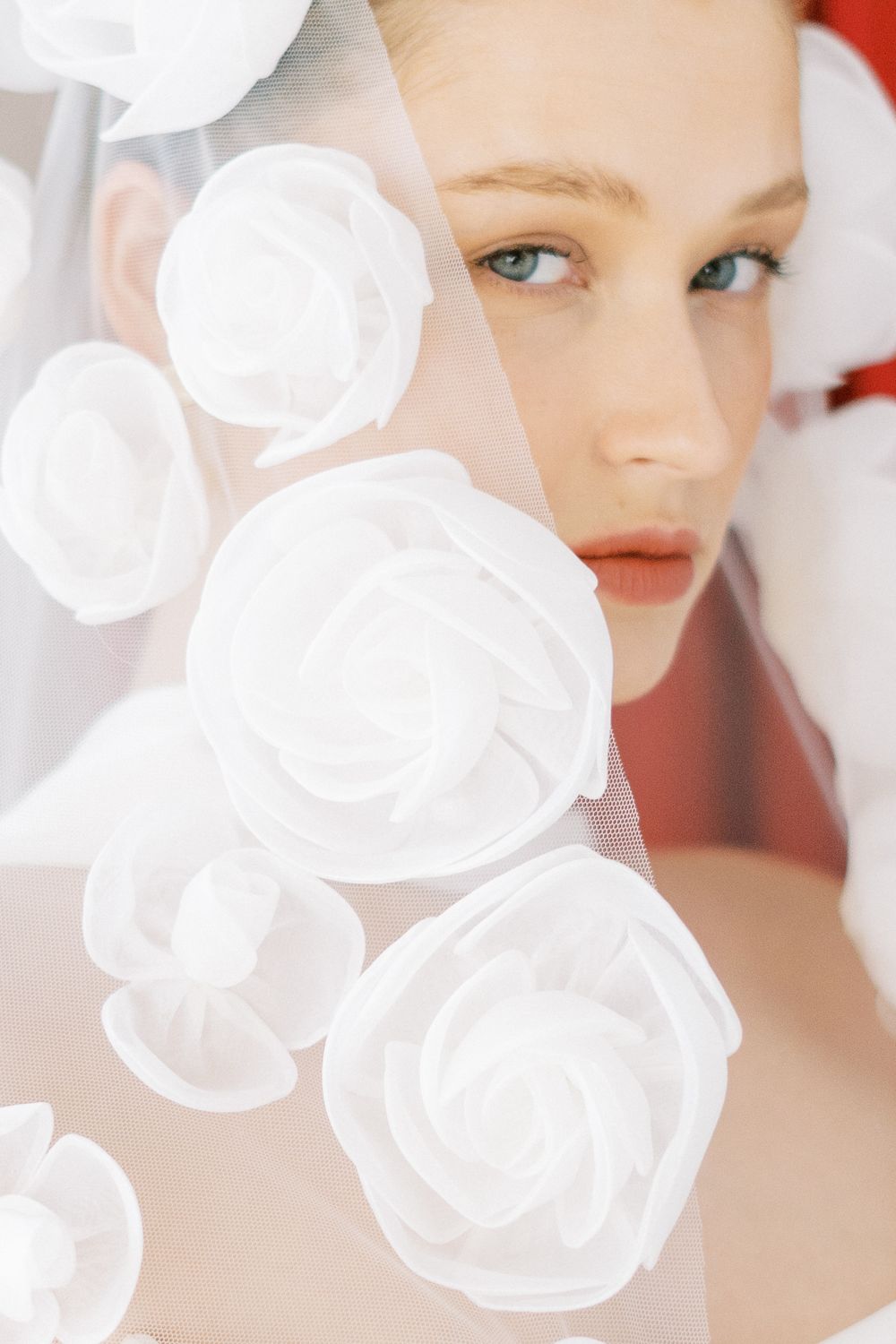 Delicate white fabric creating soft, ethereal textures against a light background.