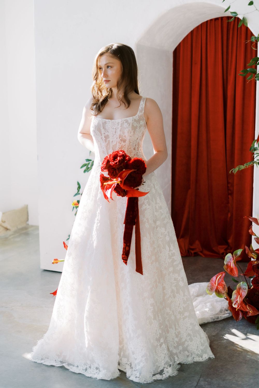 A series of four wedding dress detail shots showing the gown's lace, red ribbon accents, and flowing silhouette.
