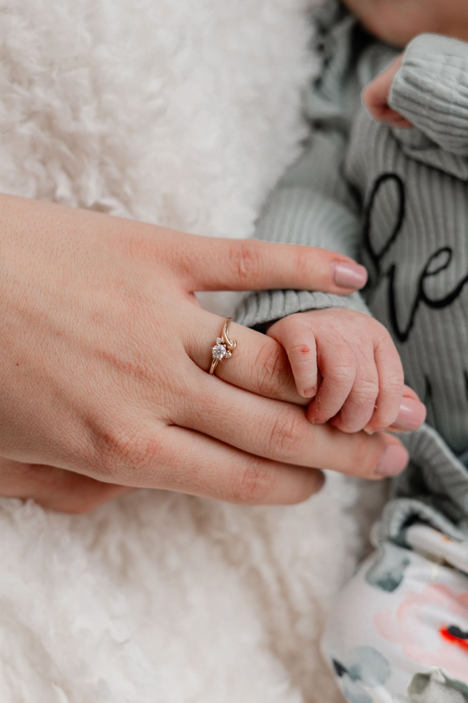 A person's hand wearing a delicate gold ring is shown from multiple angles against a light background.