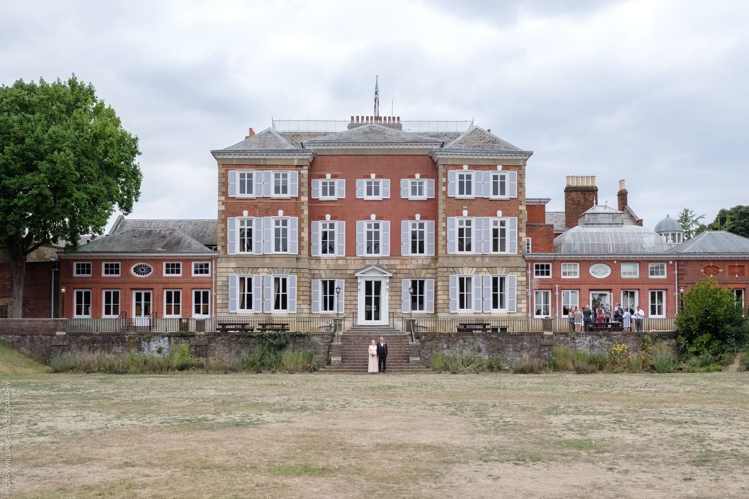 Historic Georgian-style red brick mansion with symmetrical windows and white trim seen from different exterior angles.