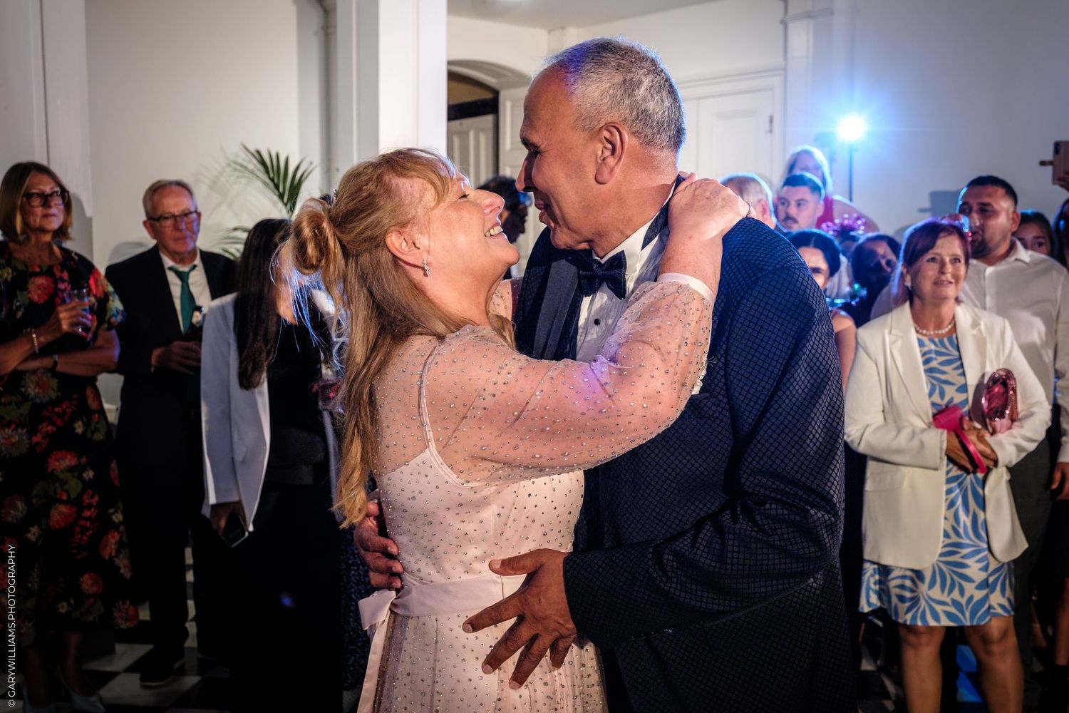 A sequence of photos showing a wedding couple dancing and embracing during their first dance at a reception.