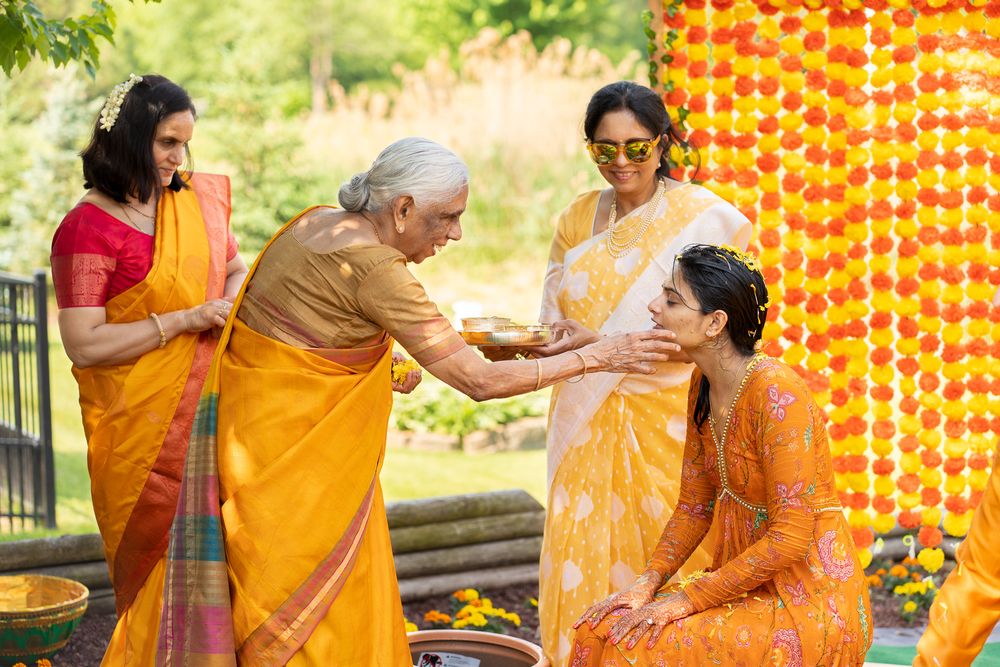 Traditional Indian wedding ceremony with family members performing. Haldi Quad Cities Photography