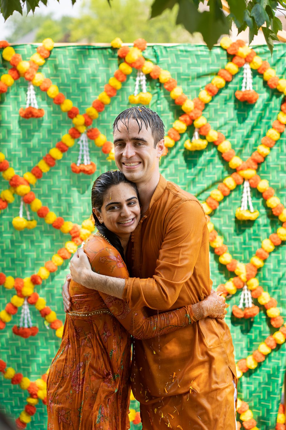 Two people embrace and laugh  Haldi Quad Cities Photography