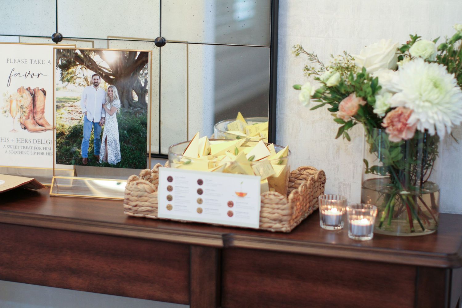 Event decor elements with flowers, signage, and rustic decorative items arranged on wooden tables and surfaces.
