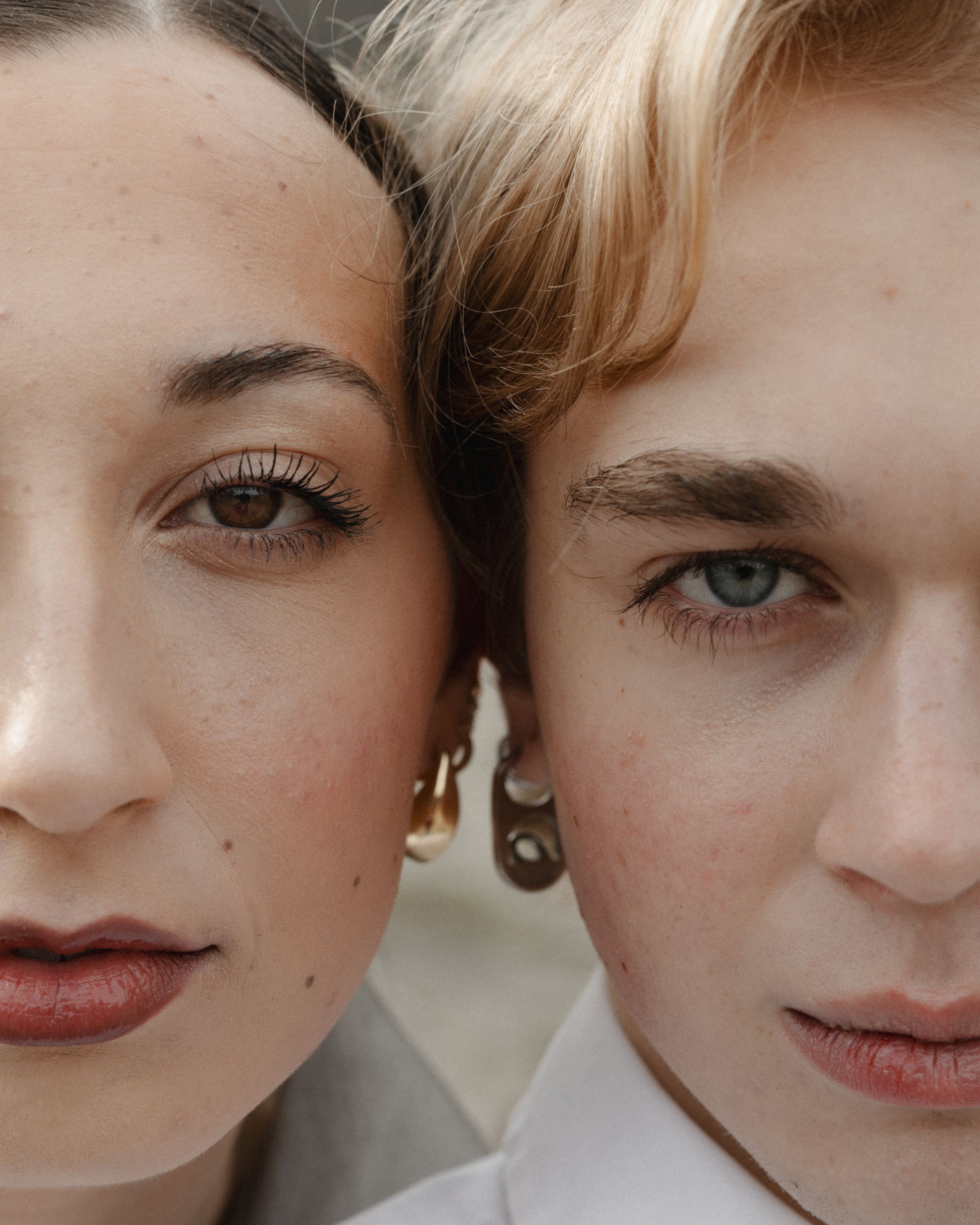 Close-up artistic portrait showing partial facial features with soft lighting and neutral tones.