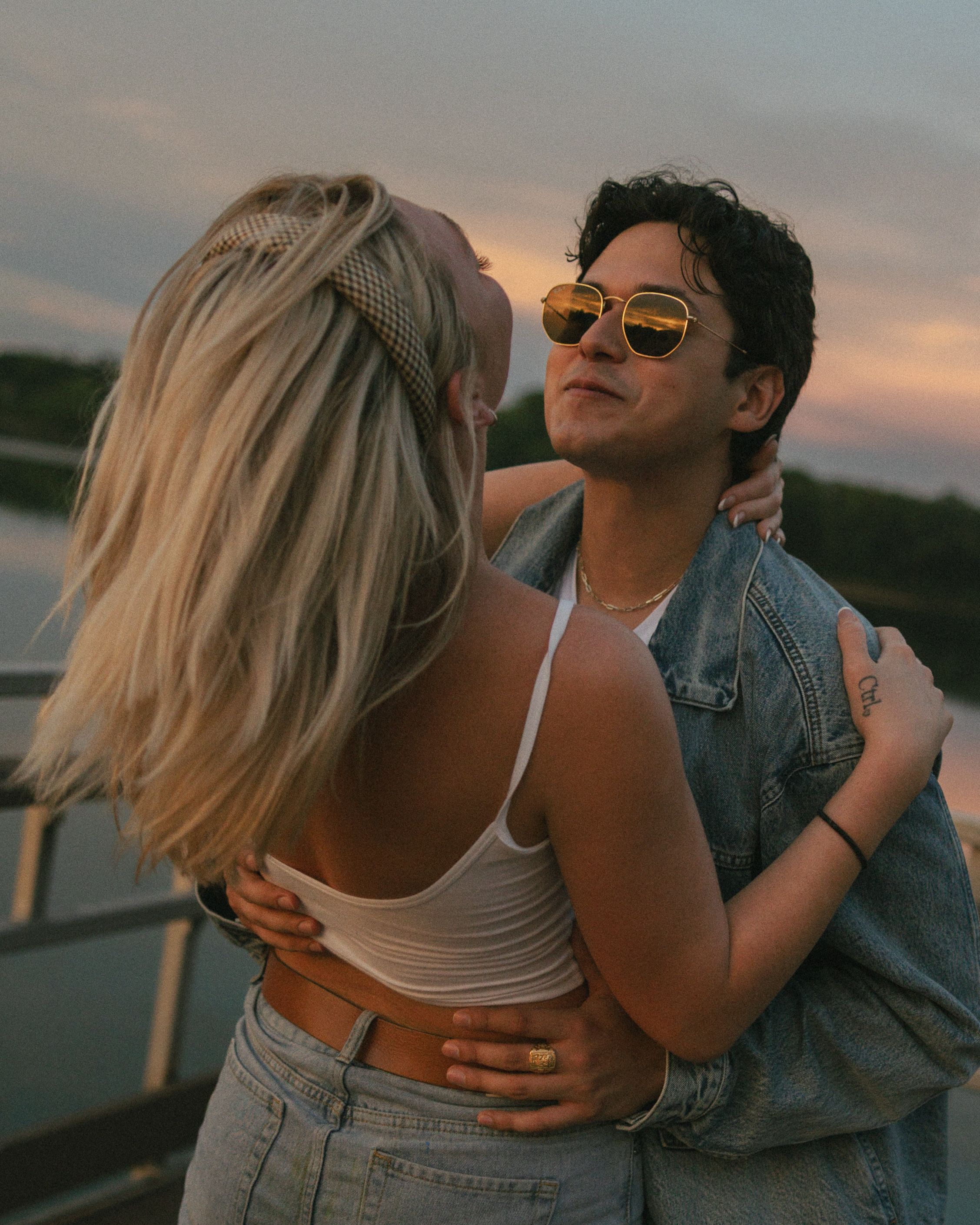 Couple sharing romantic moments together during sunset at the beach in a series of candid shots.
