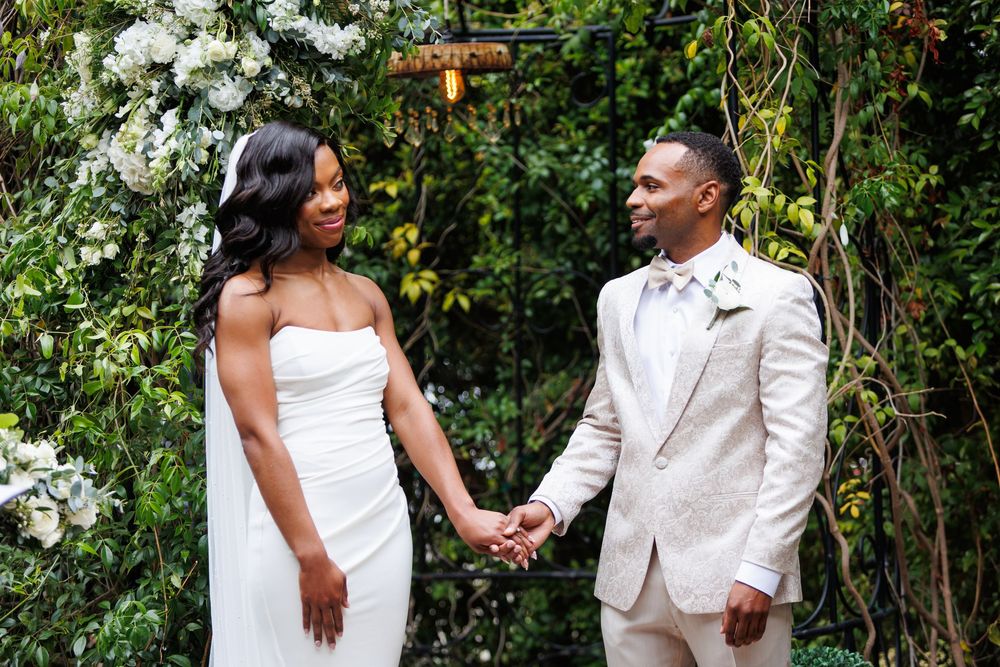 Loving couple shares special moments during outdoor wedding photography session in garden setting.
