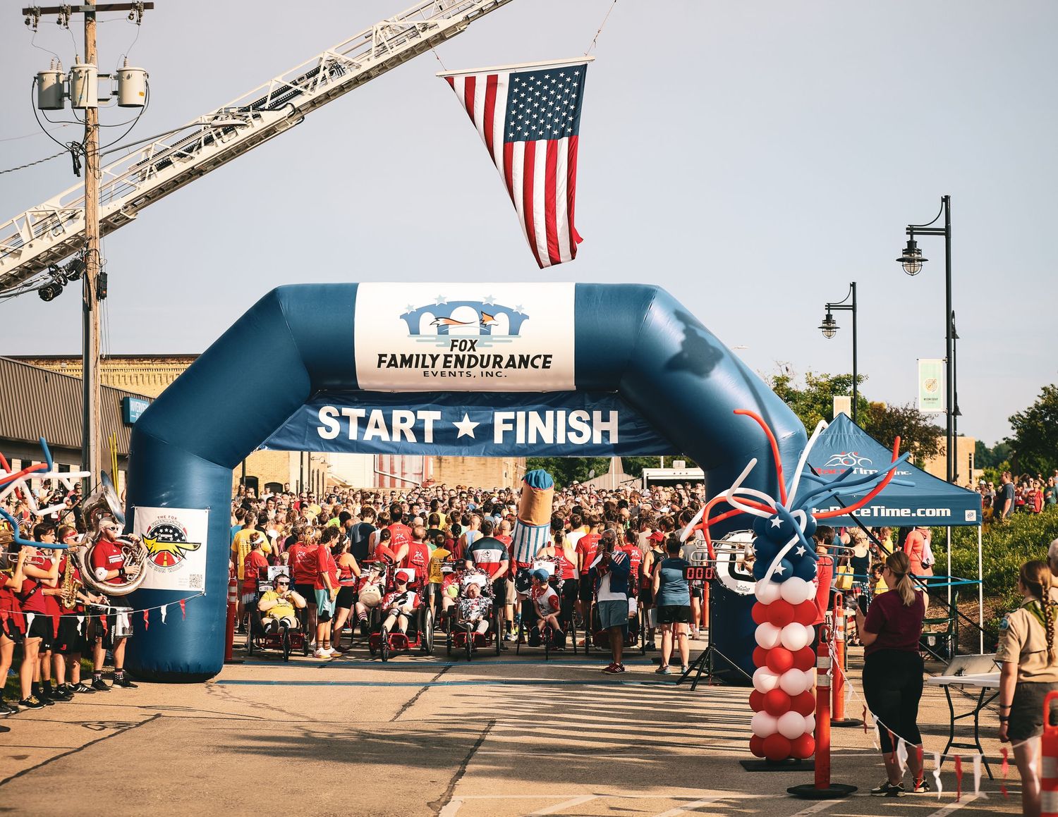 Collage of four race start/finish line scenes with American flags and inflatable arches during a community running event.