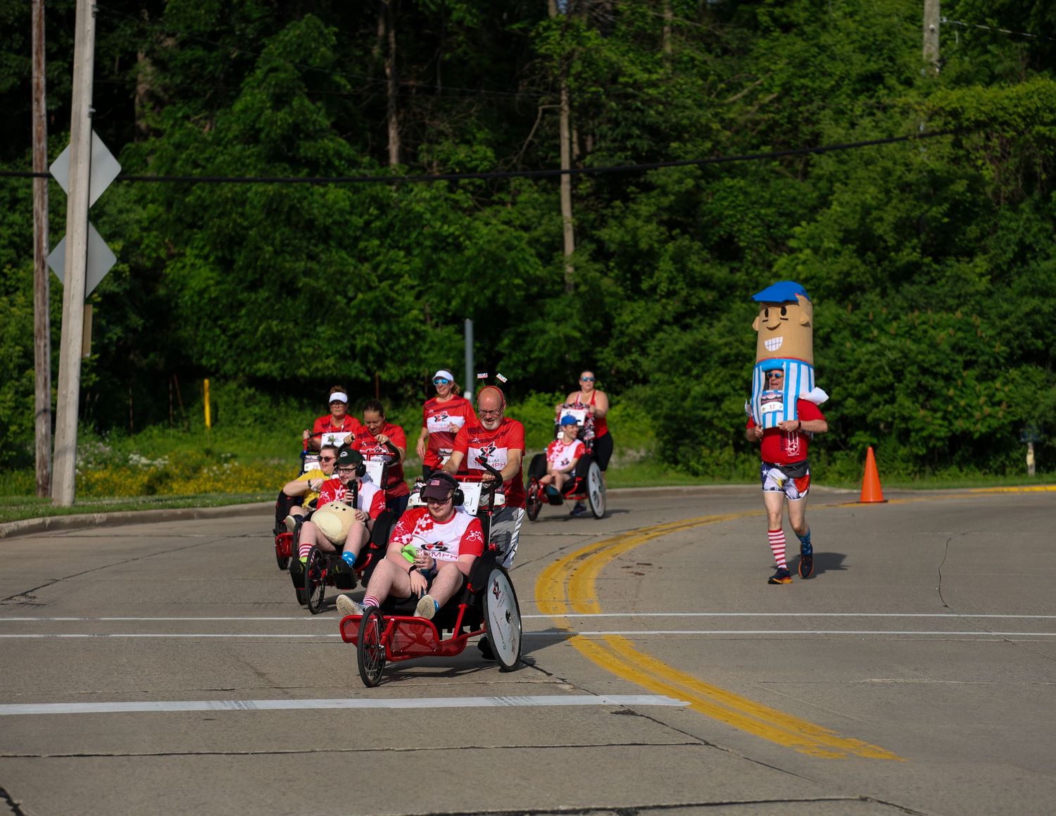 Sequence of images showing red go-karts racing around an outdoor track with trees in the background.